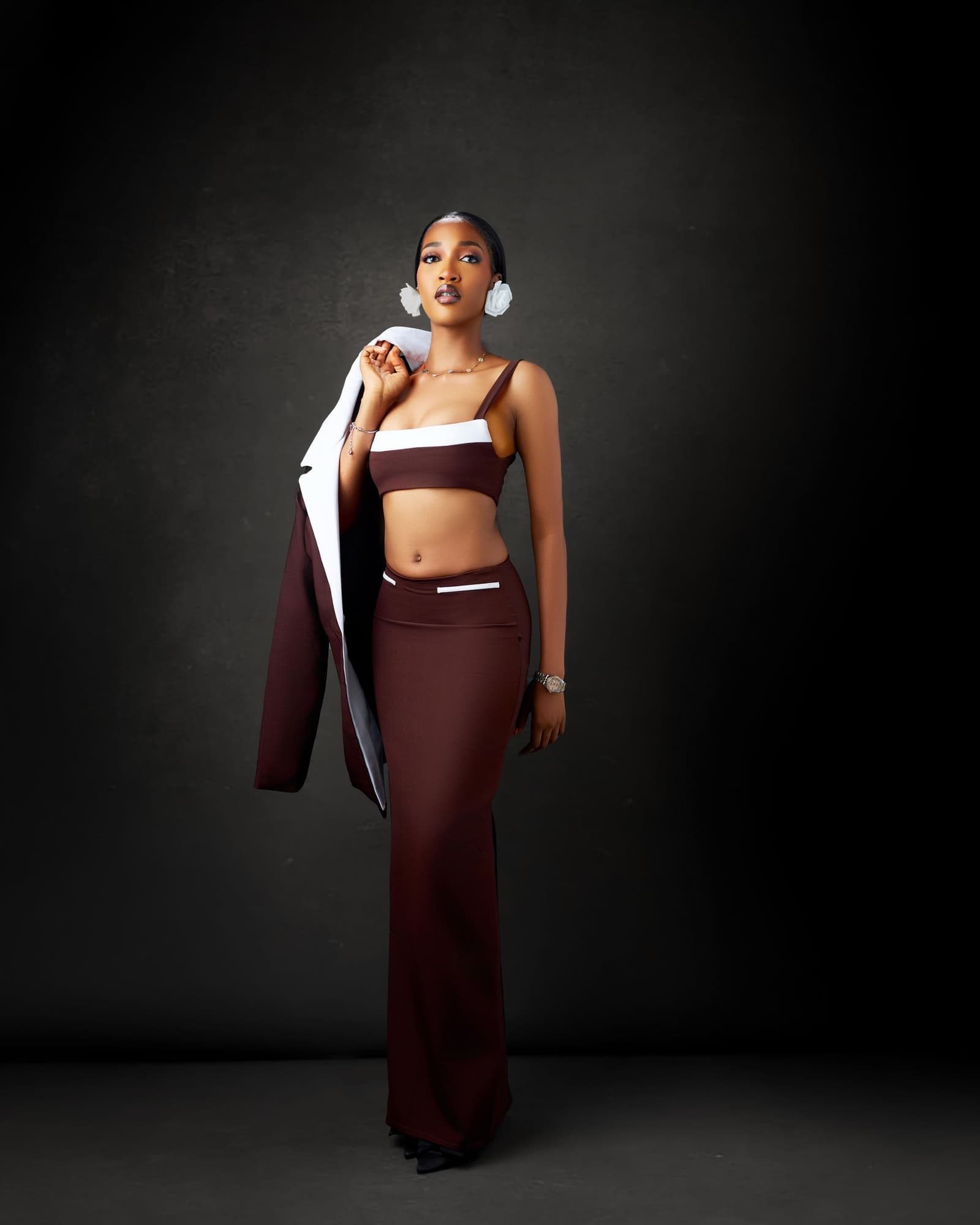 Chocolate set with the jacket hanging off one shoulder